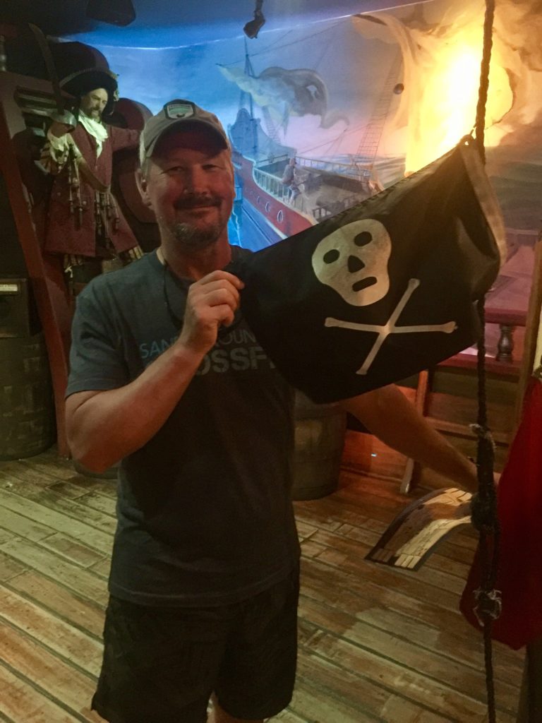 Man holding a pirate flag at St. Augustine Pirate and Treasure Museum